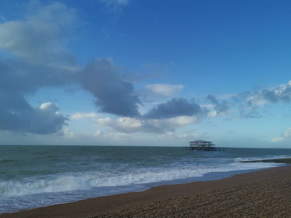 Brighton beach, old pier skeleton and blue skies