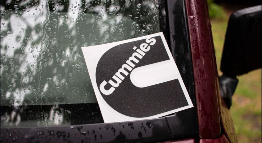An advert in a car window that just says “Cummies”