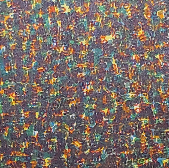 A photo of a piece of paper filled with illegible text stamped in multiple colors.