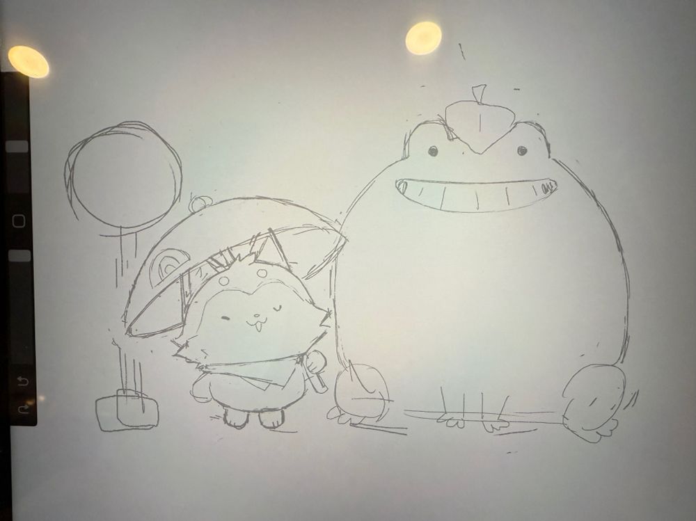 Pic of a screen with a light sketch of a smiling cartoon frog and a smiling dog waiting in the rain at a bus stop. The frog’s smile is similar to Totoro and he has a leaf on his head.