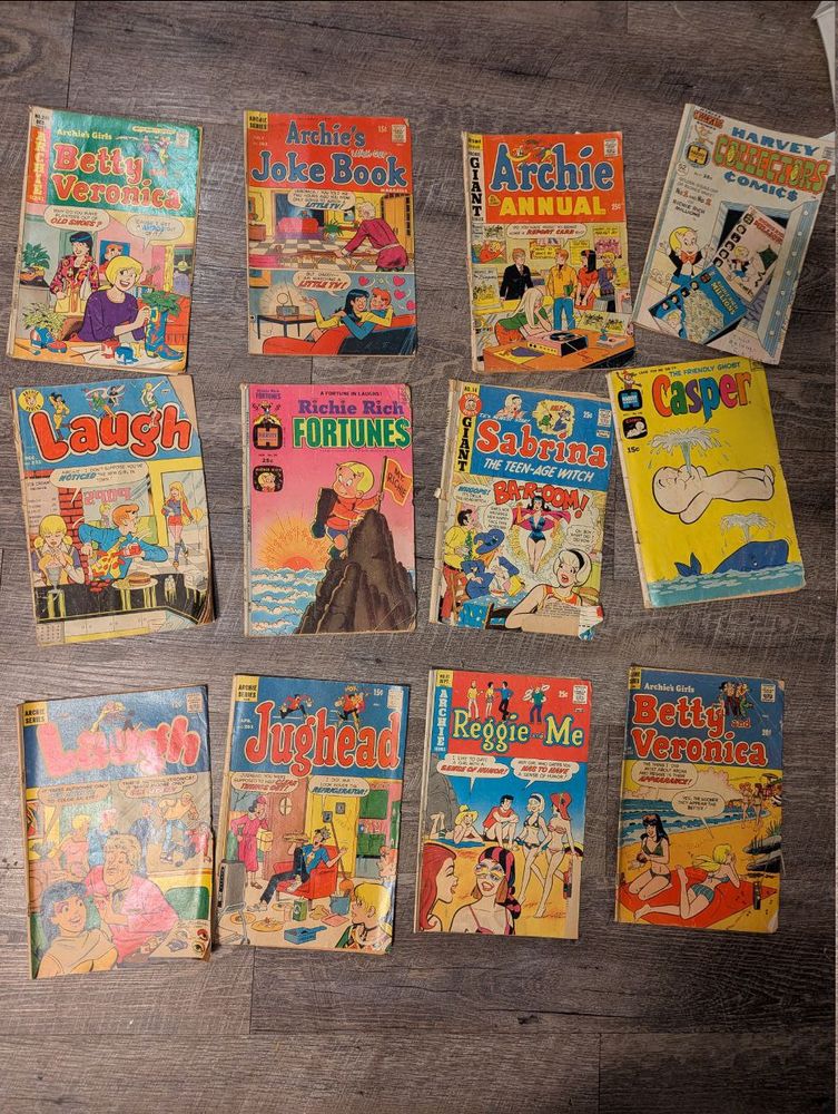 12 old comic books arrayed in a sloppy grid on the floor. Most of them are Archie comics but a few are Casper and Richie Rich as well.