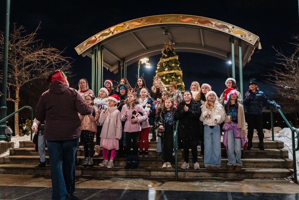 A children's choir outside singing for the Lakewood tree lighting ceremony.