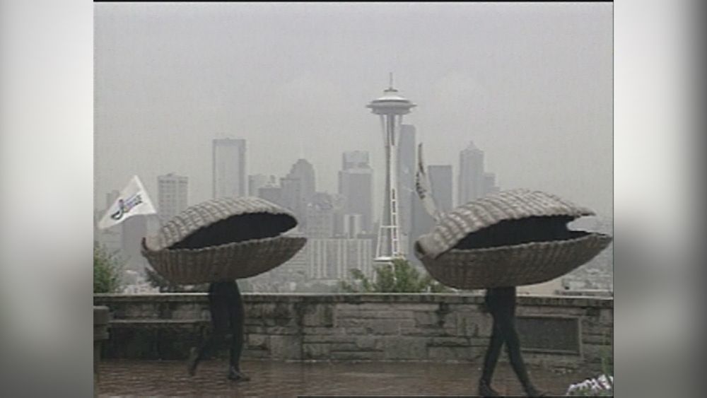 The Ivar’s dancing clams on a misty day, with the Space Needle in the background.