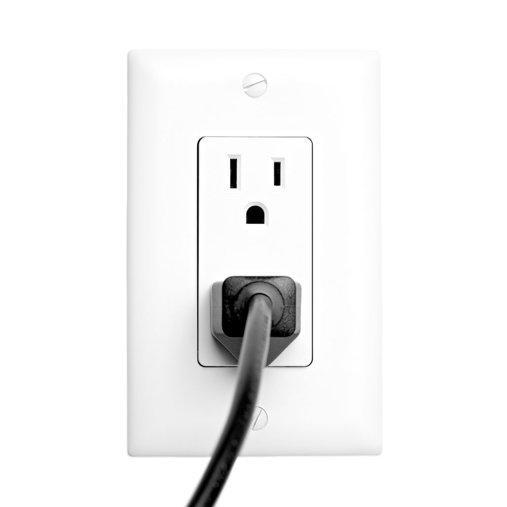 A US power outlet. It has two vertical slot openings in parallel with a semicircular opening below. The three openings bring forth the image of a simplified human face in a phenomenon called pareidolia.