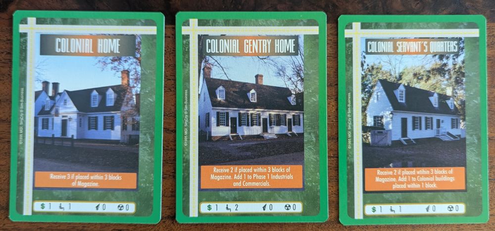 Three Sim City CCG cards, "colonial home", "colonial gentry home", and "colonial servant's quarters."