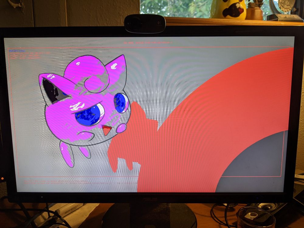 Photo of GRUB bootloader with a custom background image featuring Jigglypuff, but the color palette is glitched and incorrect