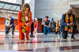 Taken during the 2020 George Floyd protests, this depicts several prominent Democratic politicians kneeling while wearing kente cloth sashes to show support for #blacklivesmatter

It is a completely meaningless gesture.