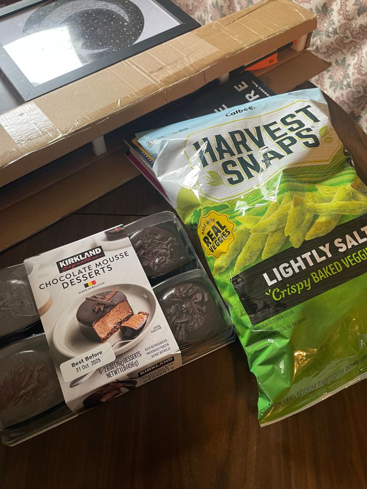 Package of small chocolate cakes next to a bag of Harvest Snaps