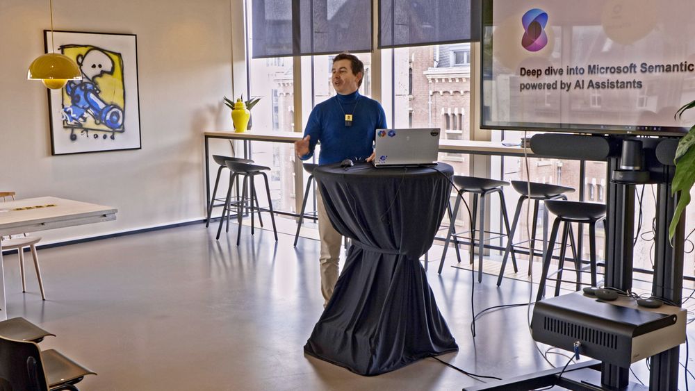 Daniel, presenting in a modern room, on a higher level floor nearby the dam square in Amsterdam.
