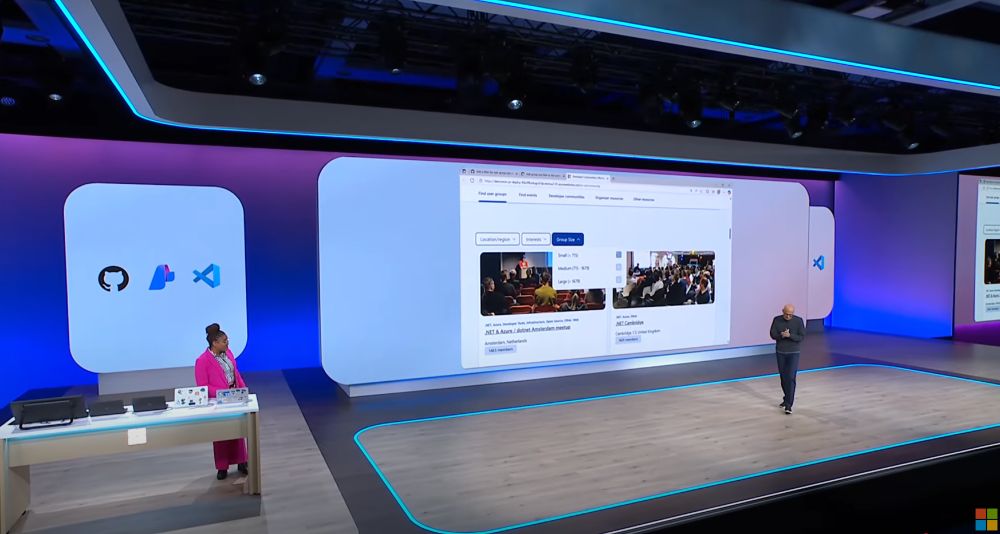 Kendasha Kerr on a large stage together with Satya Nadella demoing an application, that lists communities, with dotnet amsterdam listed.