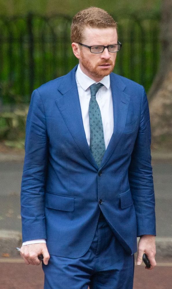 Morgan McSweeney, brow furrowed, teeth, nostrils and knuckles clenched, appalling ill-fitted blue suit (it was never nice) that looks as if he's slept in it for a month without ever undoing its fully buttoned jacket, but a clean white shirt that one imagines 5 interns had to hold him down while the 6th one put it on him, gleams out from under it. This is a man who gives a strong impression of aroma, ill-temper, and contained violence. A cornered polecat. This is the guy who sits very deliberately directly opposite you on an almost empty tube carriage, and then stares while rhythmically grinding his teeth until you get up and move.