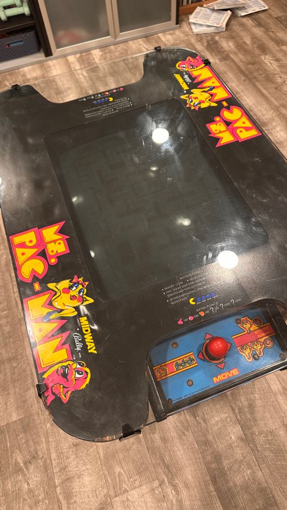 Ms. Pac-Man cocktail cabinet shown from the top of the machine that shows the monitor and control panel of the game