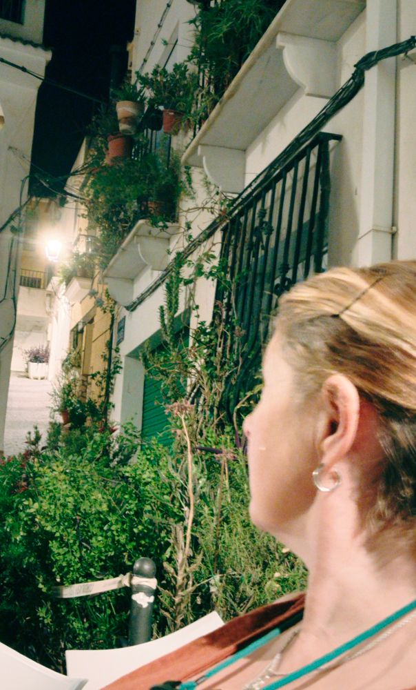 Woman looks up a Spanish street 