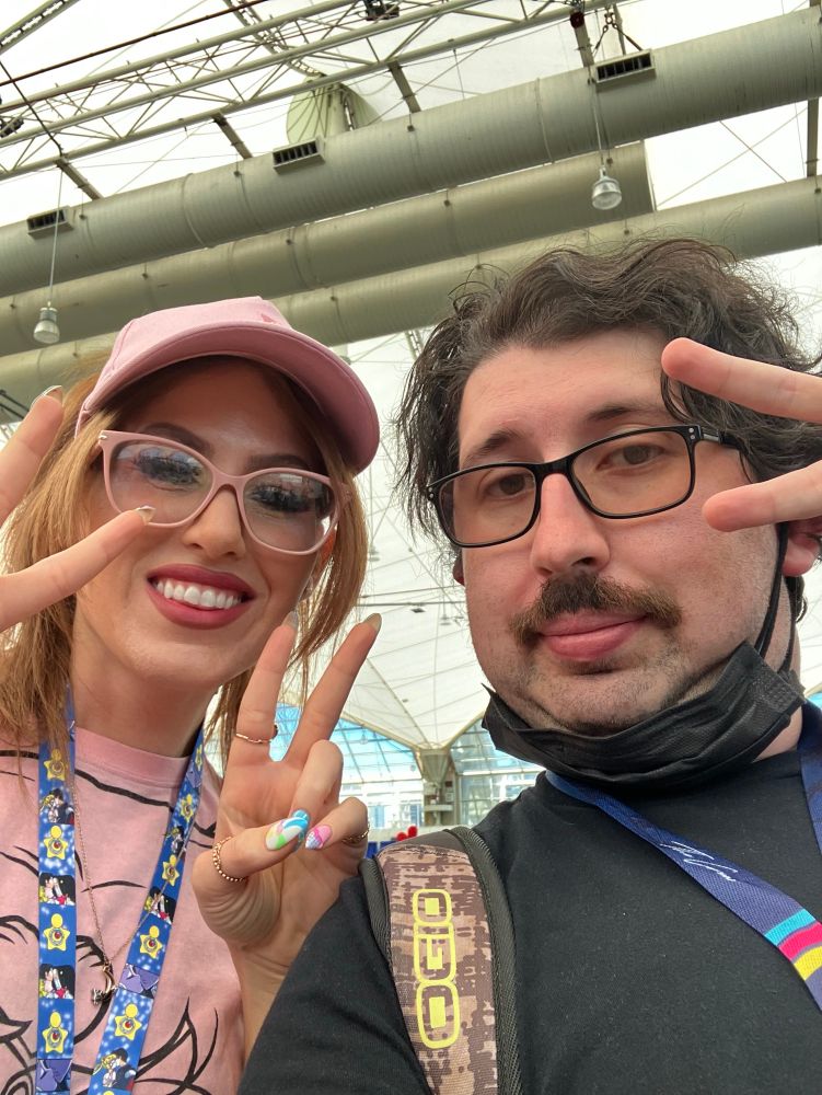 A selfie which consists of me with Brooke (Ochibawolf) next to me holding with 2 fingers sign. I was posed with 2 fingers above my face.