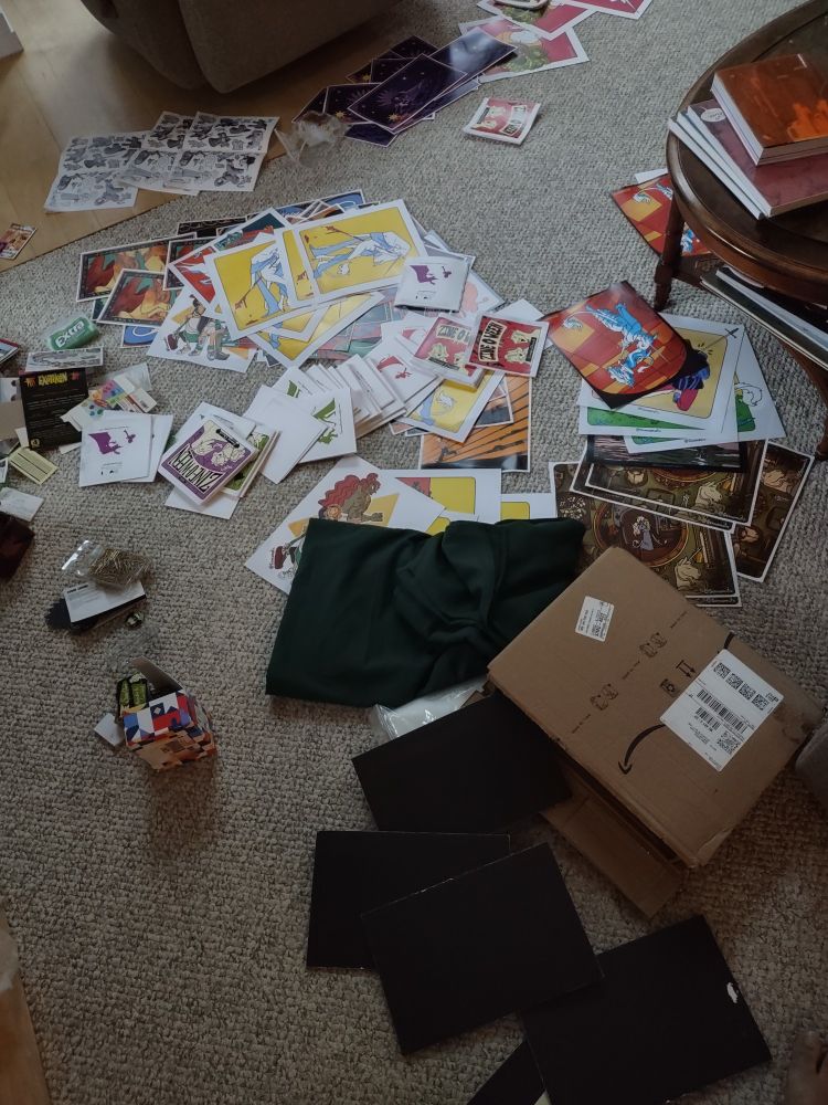 Photograph of my floor covered in waterlogged prints, zines, equipment, and promotional material.