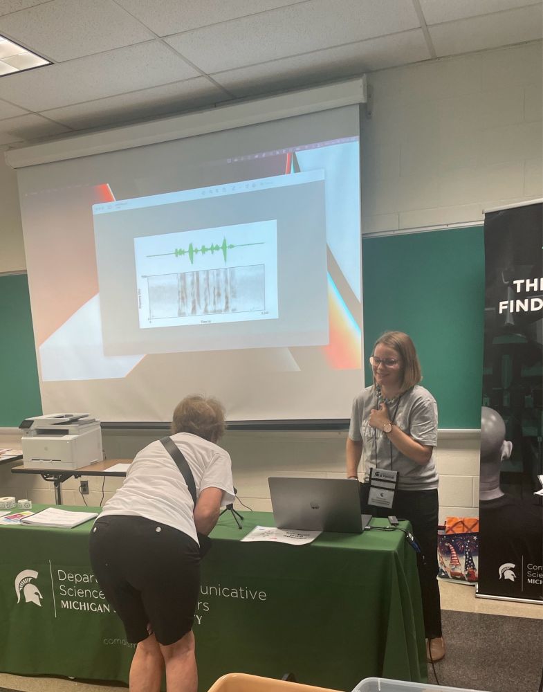 Dr.Knowles and helping a student at the SEE YOUR SPEECH station
