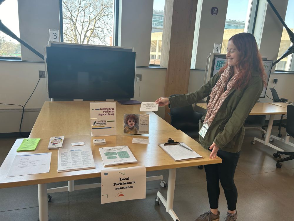 Maura at a table with lots of local Parkinson’s Disease resources.