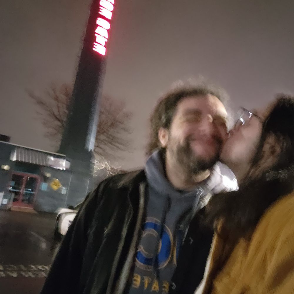 Selfie of me kissing my wife on the cheek