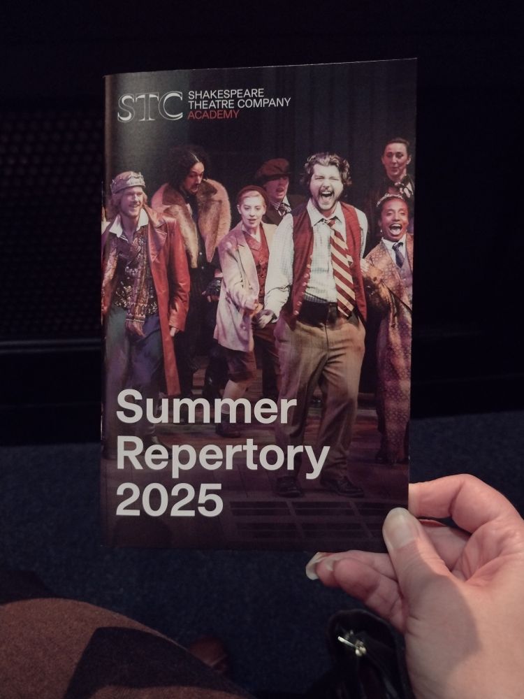 Playbill with the STC logo at top, cast photo with a king (one white, one black) to each side of other cast members, reads "Summer Repertory 2025" in bold white text.