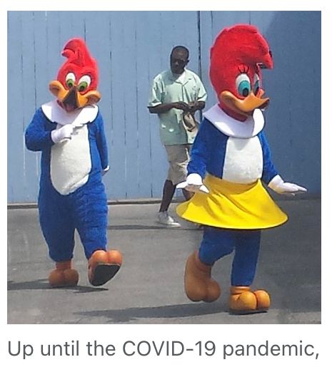 A picture of woody woodpecker at a universal theme park with the cut offed caption “up until the covid 19 pandemic”