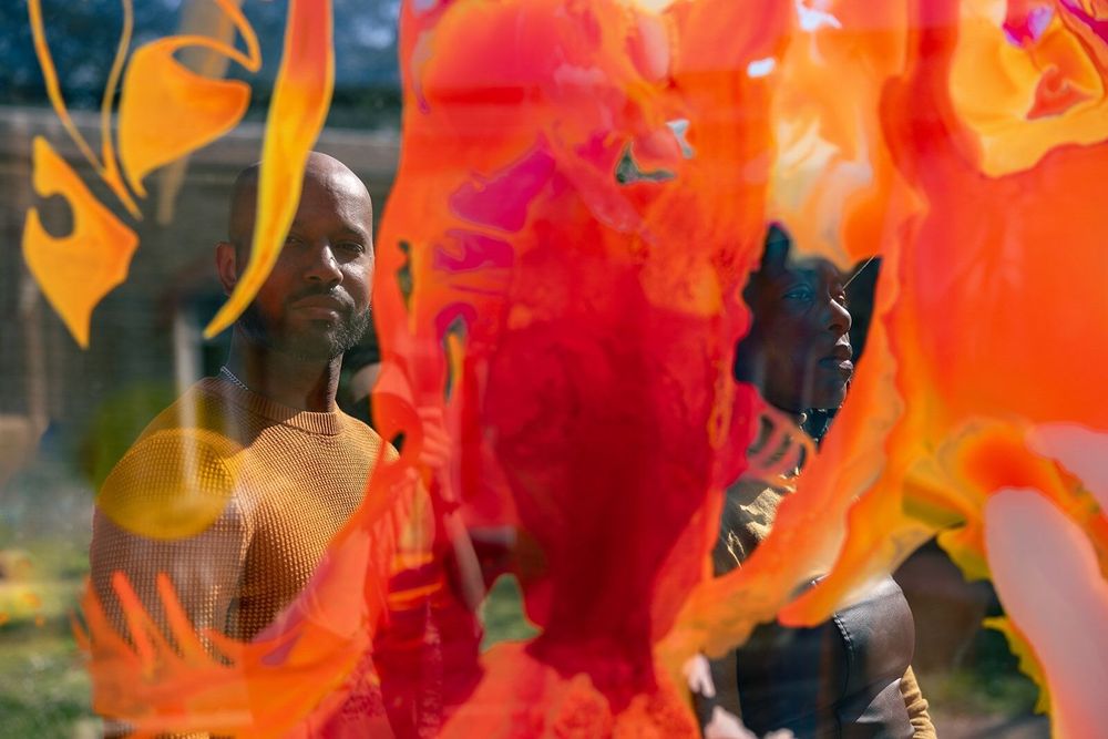 Photo of Antoine Marc and Bumi Thomas with Bryony Ella's artwork My Body is a Sundail