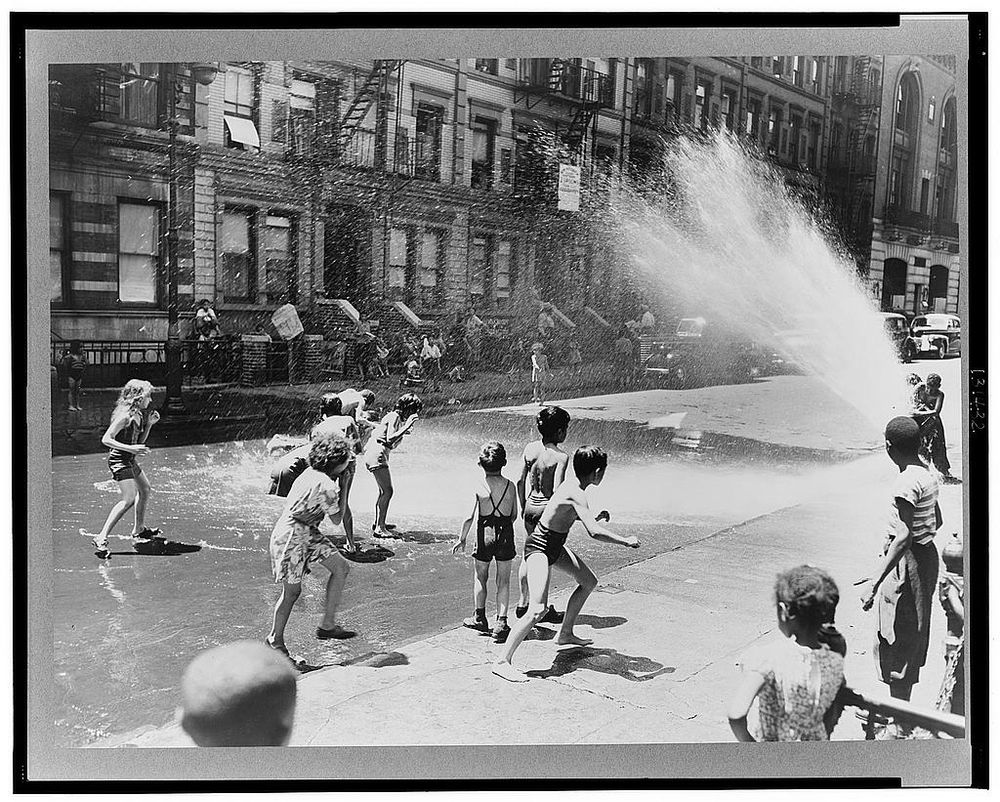 Children escape the heat of the East Side New York by using fire hydrant as a shower bath