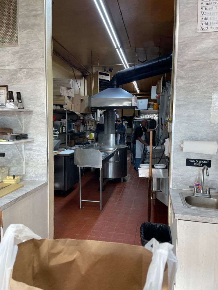 Looking back into a small bagel bakery, including the big tub for boiling the bagels. 