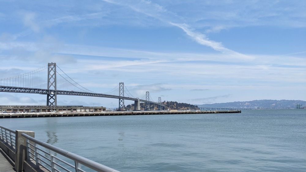 The Bay Bridge photographed from the Embarcadero in San Francisco; Treasure Island in the background