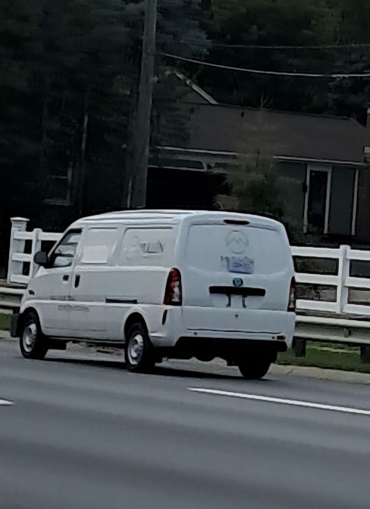 A Mullen One van driving on its own power in Metro Detroit with Mullen branding all over it. 