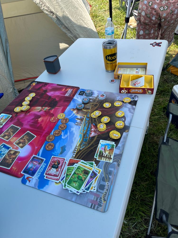 A table with Jaipur board game on it 