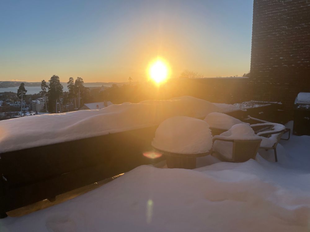 Nice weather and snowy outdoor furniture. No clouds on the sky