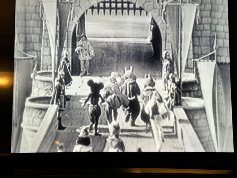 The Disney characters heading into Fantasyland 