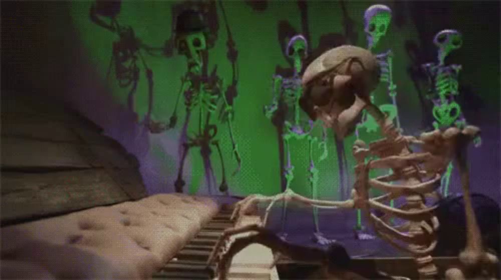 a skeleton is playing a piano in front of a group of skeletons in a room .