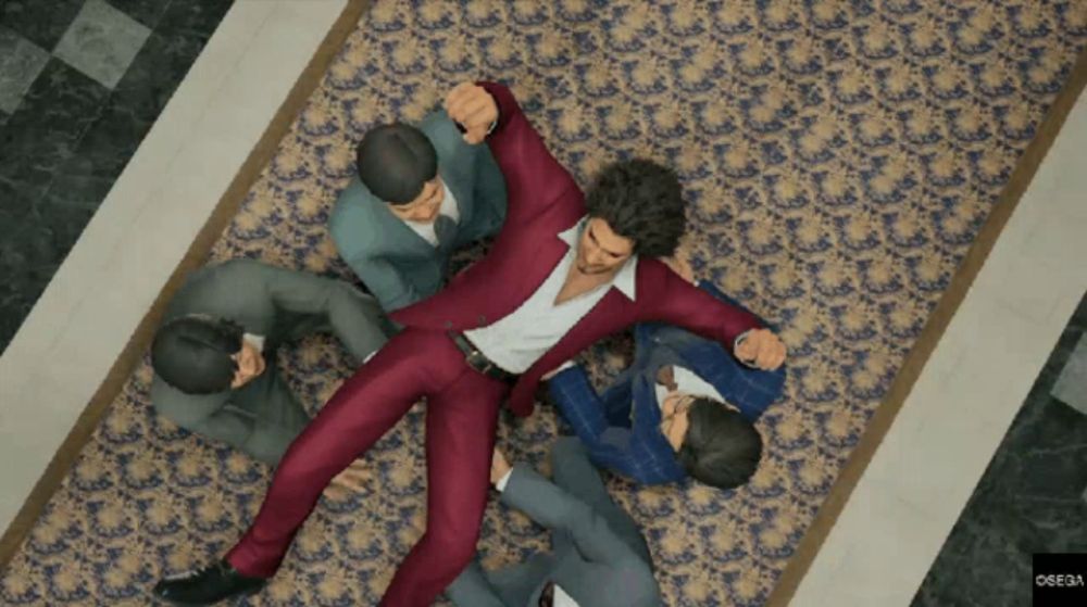 a man in a red suit is laying on the floor surrounded by men in suits