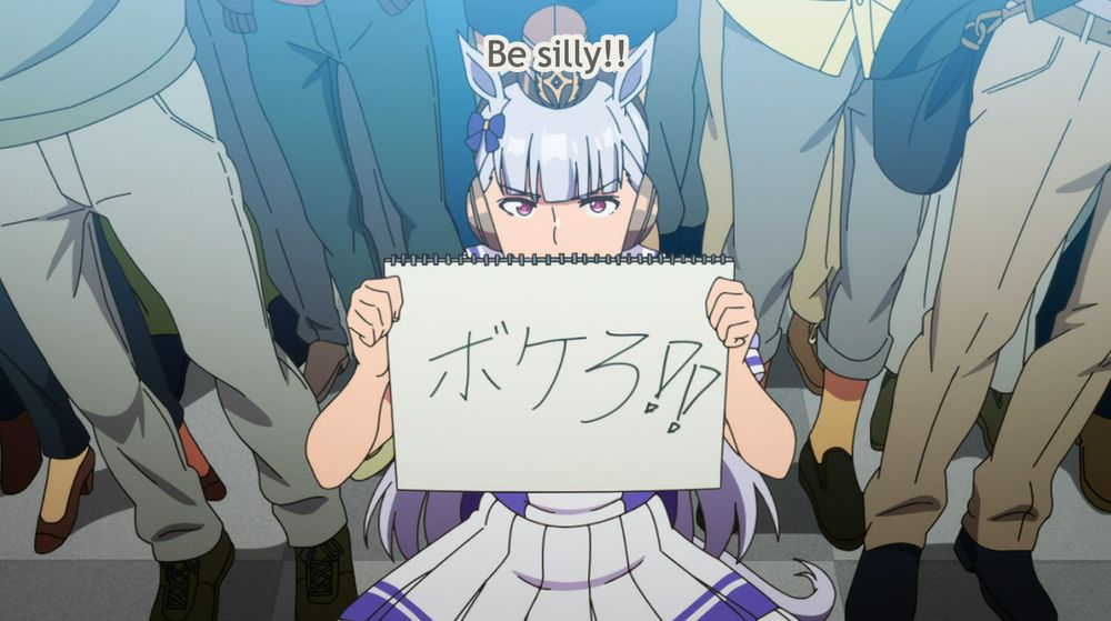 a screencap from the Umamusume anime in which Gold Ship holds up a handwritten sign, translated by the captions as saying "Be silly!!"