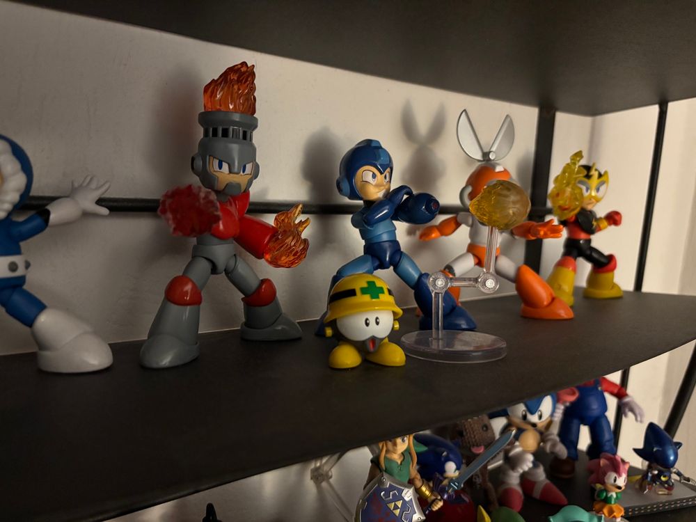 one of the Met figures on a shelf next to the other Jada Toys Mega Man figures