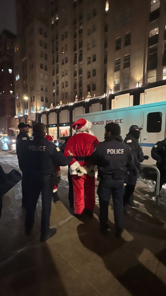 The organizers were handcuffed by Chicago Police officers as they blocked off Michigan Avenue lanes headed north. 

📸: Corli Jay for The TRiiBE