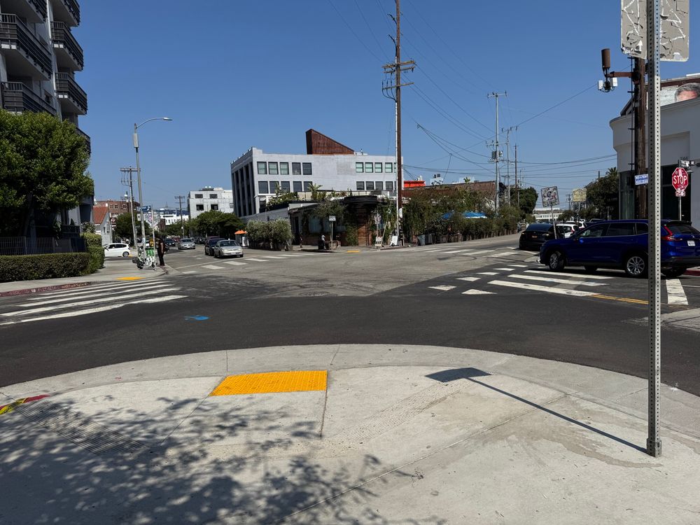 Looking out at the intersection from an extended curb with a new ADA ramp on Traction and 3rd.