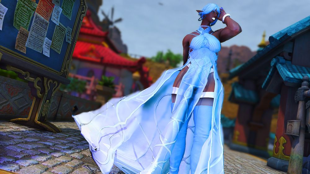 A Black Elezen posing in an elegant, billowing, blue-and-white dress.