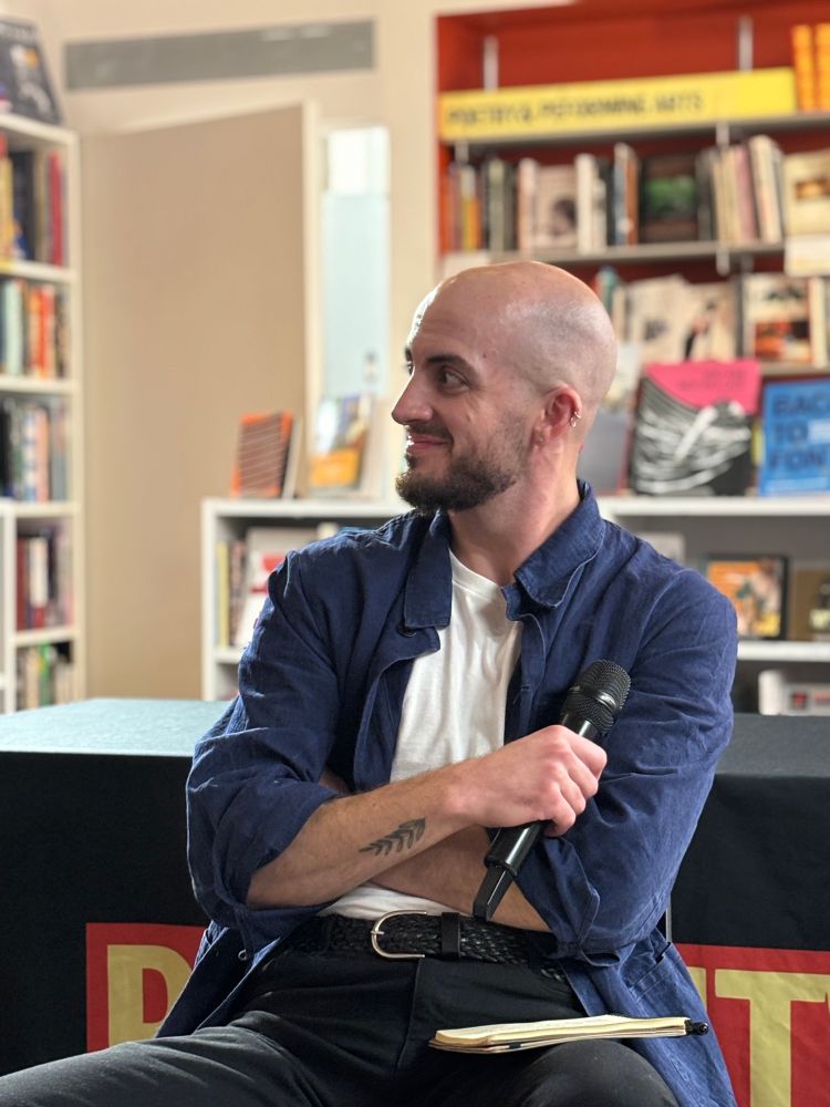 Calvin Kasulke, a white trans man in a blue shirt