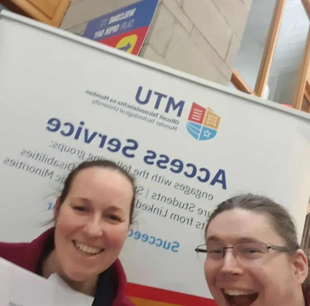 Emily and Adrian standing in from of the MTU Access Service sign 