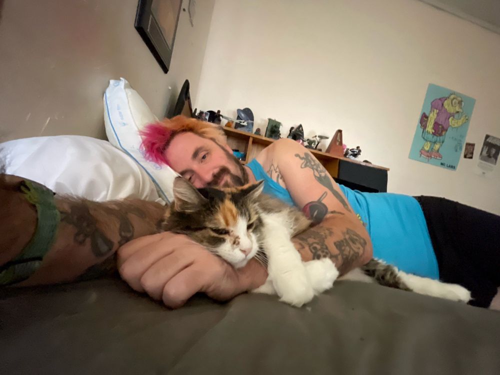 DUDE BEING ATTACKED BY A VICIOUS, SHARP-FANGED PREDATOR THAT ONLY LIVES TO EAT!!!!

My cat cuddling my arm