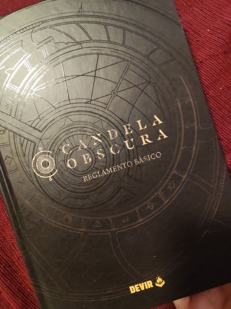 Foto del manual en físico de reglamento básico de Candela Obscura. Editorial Devir.