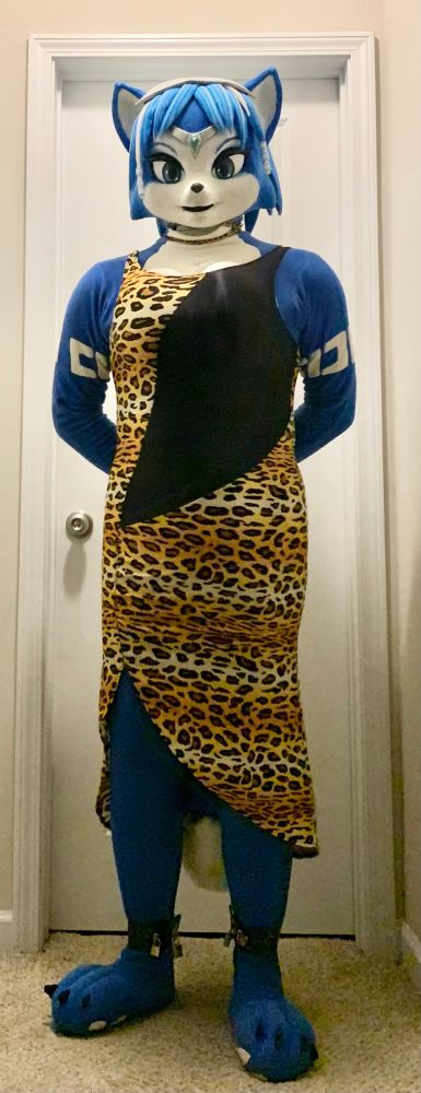 Photo of myself wearing my fleece Krystal (Star Fox) cosplay. In addition to being locked in with 8 different padlocks located at the zipper, ankle cuffs, wrist cuffs, and collar chain, im also wearing a long, formal, leopard-print dress.

Alt pose with hands behind my back.
