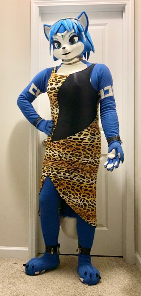 Photo of myself wearing my fleece Krystal (Star Fox) cosplay. In addition to being locked in with 8 different padlocks located at the zipper, ankle cuffs, wrist cuffs, and collar chain, im also wearing a long, formal, leopard-print dress.
