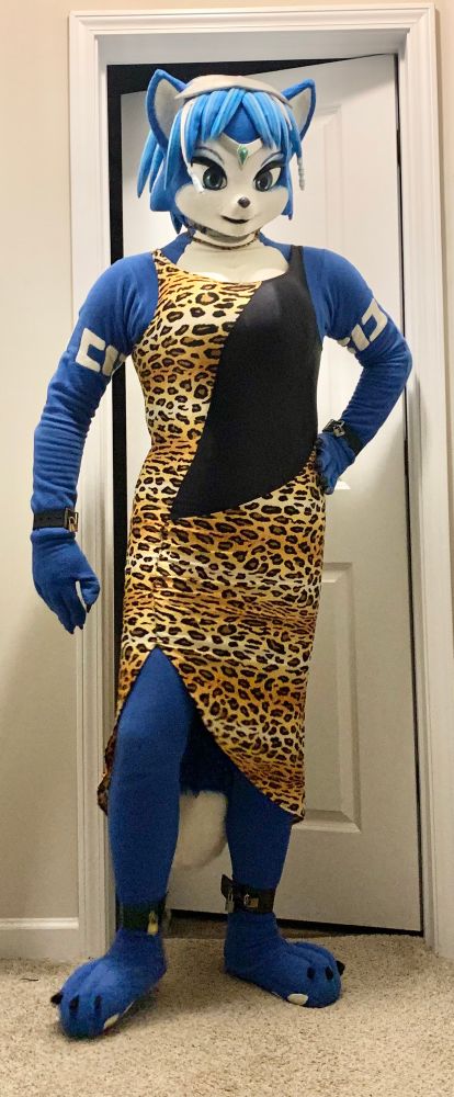 Photo of myself wearing my fleece Krystal (Star Fox) cosplay. In addition to being locked in with 8 different padlocks located at the zipper, ankle cuffs, wrist cuffs, and collar chain, im also wearing a long, formal, leopard-print dress.