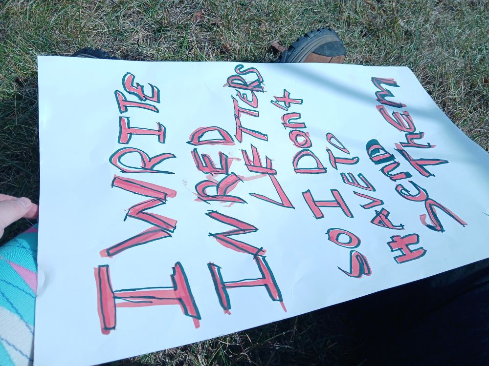 A sign in 1930s Esq advertising style that reads "I write in red letters so I don't have to send them"