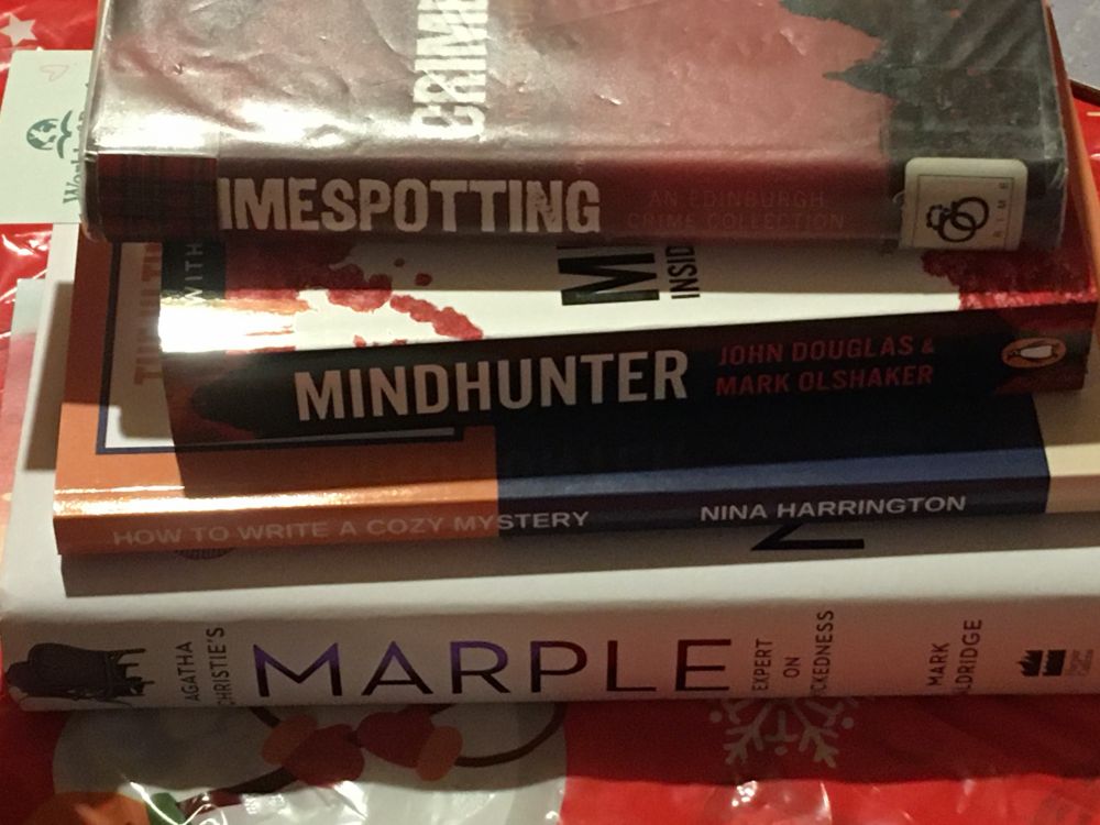 A pile of books covering a variety of crime topics.