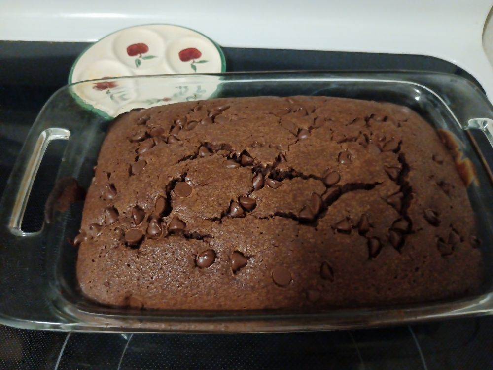 Freshly baked brownies in a glass casserole dish.