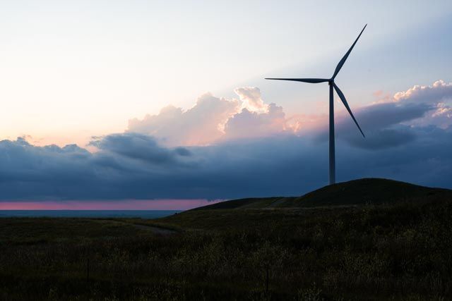 Silhouette of a windmill against a sunset.